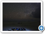 Travellers sleeping under the stars on top of sand dunes in the Zahik desert.